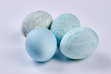 Blue eggs on white surface. Dyed Easter eggs, close up.