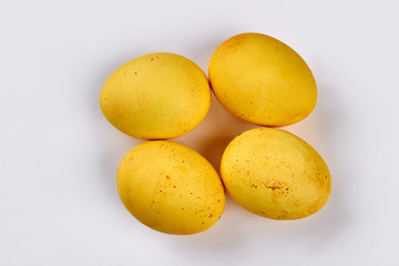 Yellow dyed eggs. Chicken eggs on white background.