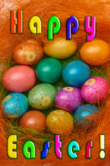 Happy Easter. Colorful Easter eggs in a basket on the artificial grass and Text Happy Easter