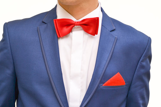 Man in blue suit with red handkerchief, close up