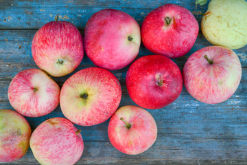 Natural ripe red apples on a blue background