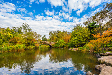 The Gapstow Bridge over The Pond in Central Park, New York, New York, USA, on an autumn day.