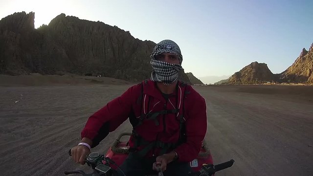 Driving ATVs in the Desert of Egypt. Riding on Quad Bikes in the Desert of Egypt. Adventures of desert off-road on ATVs. First-person view on action camera.