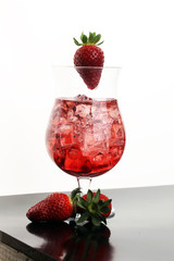 Red drink with ice, strawberry and juice. Aperitif. Cocktail with ice