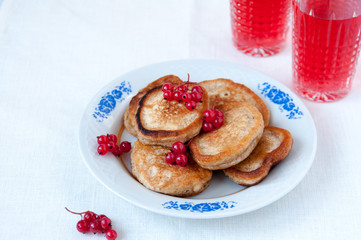 Pancakes with berries red currant and juice