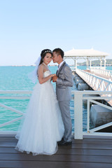 Pre Wedding photography thai couples on a wooden Atsadang bridge of Koh Si Chang Island at Thailand.