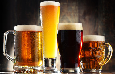 Four glassed of beer on wooden background