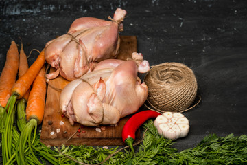 Chicken with soup ingredients - herbs and spice before baking in the oven. Dark background for a menu book of recipes or design. Horizontal top view. Text area. 