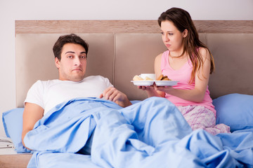 Happy family having breakfast in bed