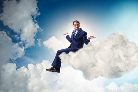 Businessman sitting on the cloud in motivitation concept