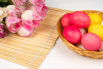 easter background, colorful eggs in basket with tulips