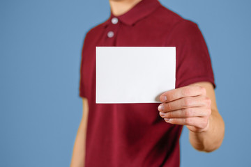 Man showing blank white flyer brochure booklet. Leaflet presentation. Pamphlet hold hands. Man show...