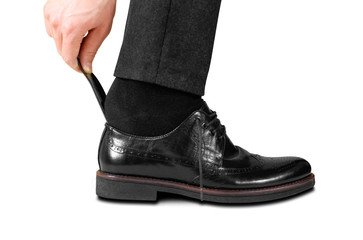 Wearing black shoes with a spoon. Isolated on white background