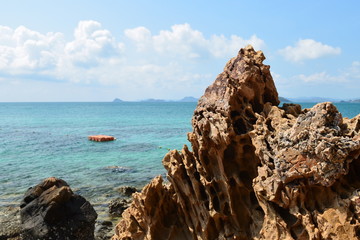 Beautiful stone on the beach with blue sea and sky background,kohkham underwater park,chonburi province, thailand