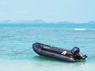 Empty black inflatable boat in the sea