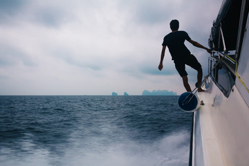 Naklejka premium Man looking at sea horizon. Horizontal outdoors shot of silhouette of person admiring the waterscape.