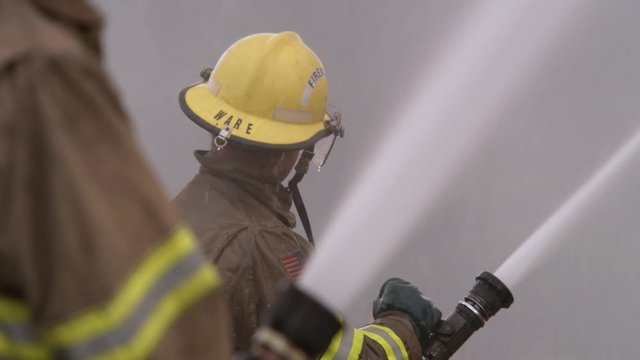 Fireman spraying water from a hose