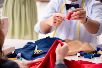 Young man tailor working with female client