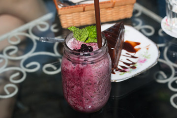 Organic Blueberry Smoothy made with fresh ingredients with chocolate cakes

