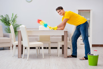 Man cleaning the house helping his wife