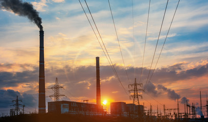 Fototapeta na wymiar Power station at dusk and power lines