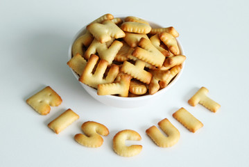 A bowl of cookies with inscription from the cookies on the white background.