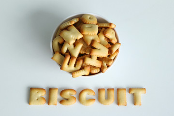 A bowl of cookies with inscription from the cookies on the white background.