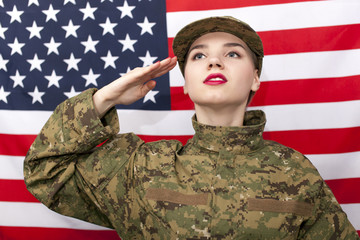 Woman soldier salute in front of  American flag.Portrait