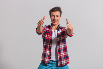 happy young casual man making the ok thumbs up