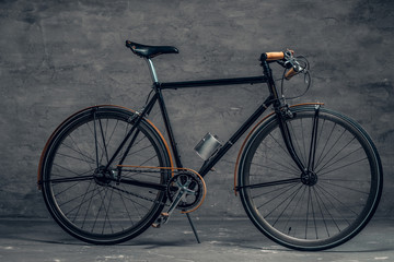 An authentic vintage single speed bicycle over grey background.