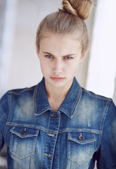 Blond female dressed in a denim jacket.