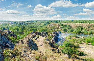 Fototapeta na wymiar River with rapids and a rock outcrops on its banks