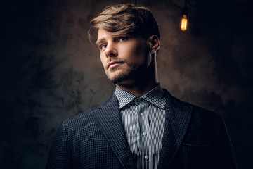 Portrait of stylish male over grey background.