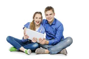 Teen boy and girl sitting with tablets