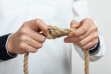 A sailor tie a sea knot