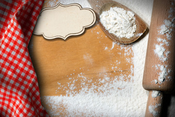 Wooden Rolling Pin and Flour on a Table