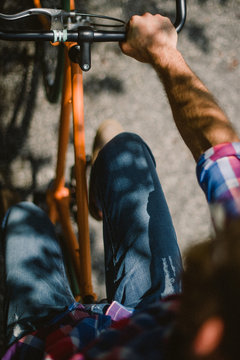 close up of a guy riding an orange bike