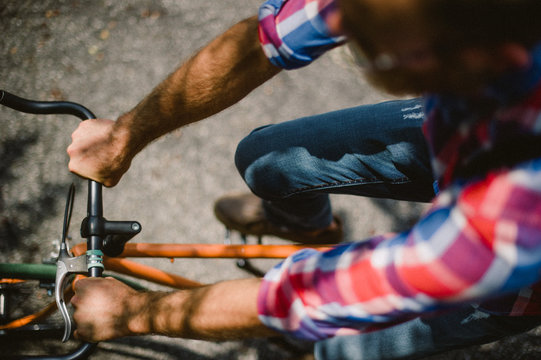 close up of a guy riding an orange bike