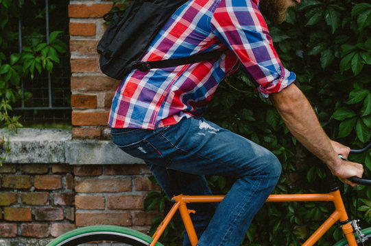 close up of a guy riding an orange bike