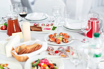 Restaurant table with food. Tasty appetizers, salads. Different meals for the guests on the wedding table