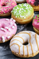Glazed donuts with different fillings on a black background