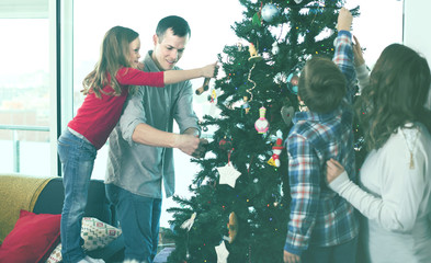 Cheerful family members preparing for Christmas