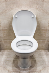 Toilet bowl white with accessories in the bathroom