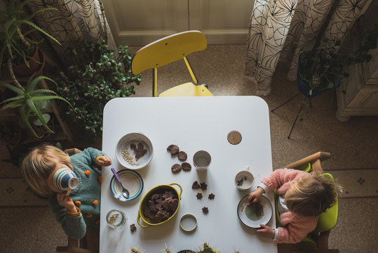 Overhead view of girl having breakfast with cookies