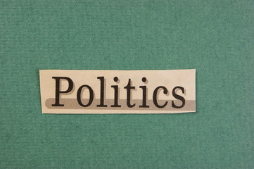 word politics cut from newspaper on green background
