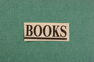 word books cut from newspaper on green background