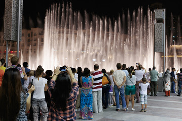 Obraz premium Night view fountains downtown and in a man-made lake, Dubai UAE