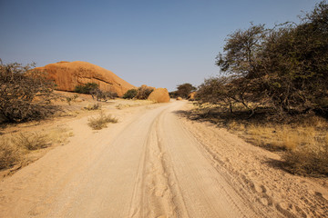Street in the Namibian savannah with blue sky