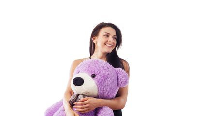 Beautiful brunette woman hugging teddy bear and smiling. Isolated, white background. Lingerie.