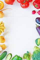 Rainbow colored veggies frame over white table. Healthy eating / diet. Juice ingredients. Copy space.